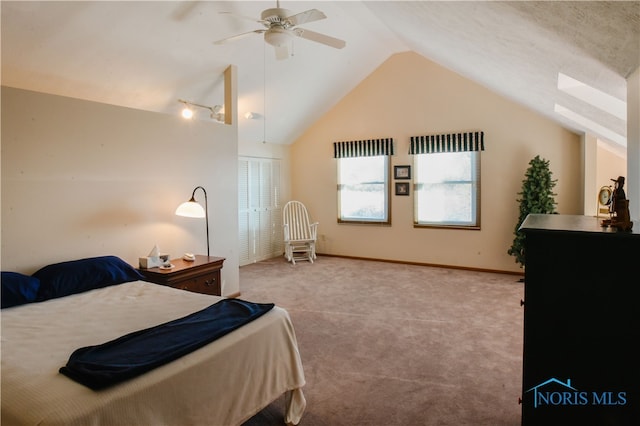 bedroom featuring light colored carpet, ceiling fan, vaulted ceiling, and a closet