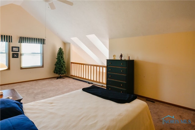 bedroom with ceiling fan, lofted ceiling, and carpet