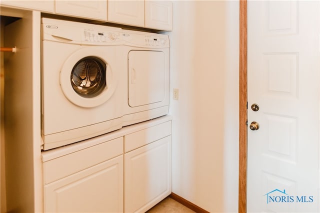 laundry room featuring separate washer and dryer and cabinets