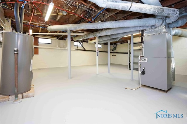 basement with water heater and heating unit