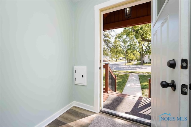 doorway to outside with wood-type flooring