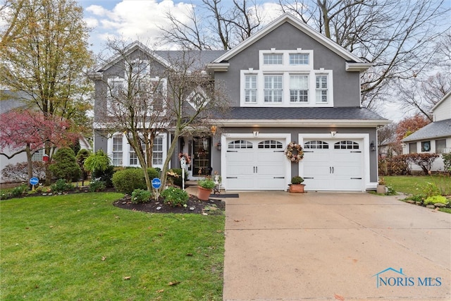 view of front facade with a front lawn and a garage