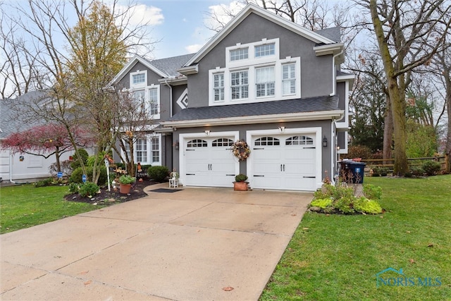 view of front of home featuring a front yard and a garage