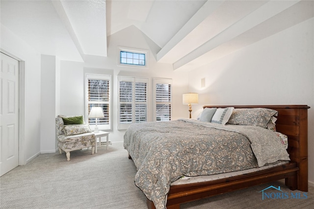 carpeted bedroom featuring multiple windows and lofted ceiling