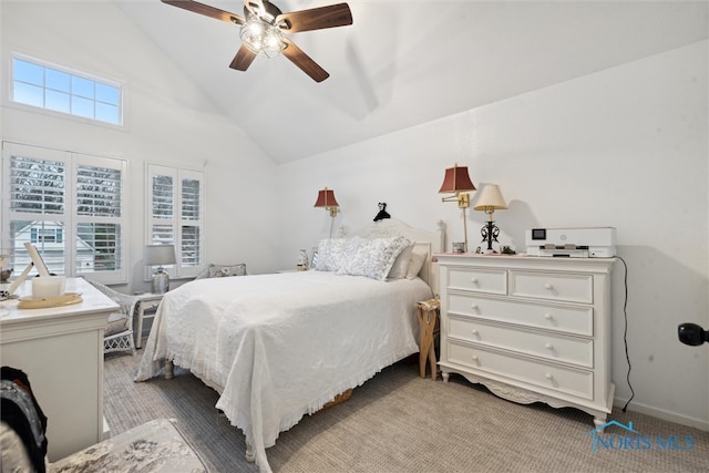 carpeted bedroom with vaulted ceiling and ceiling fan