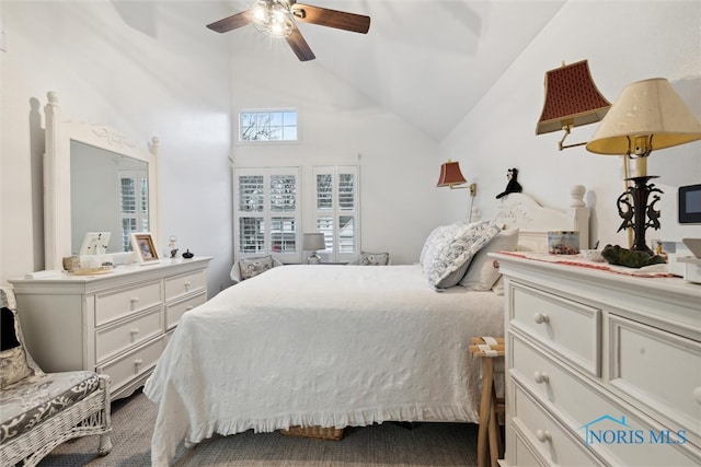 carpeted bedroom featuring ceiling fan and high vaulted ceiling