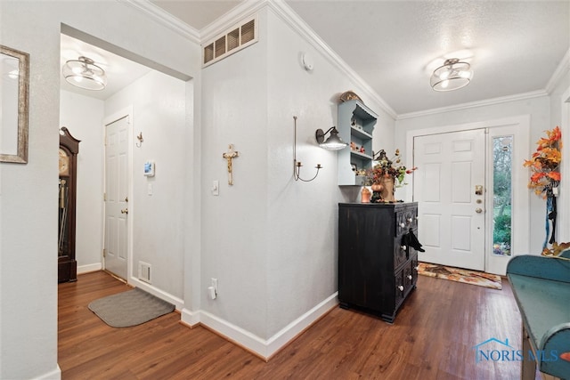 entrance foyer featuring dark hardwood / wood-style flooring and ornamental molding