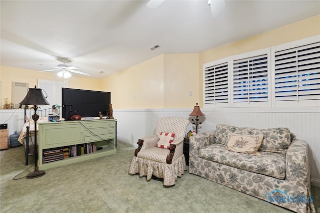 carpeted living room featuring ceiling fan