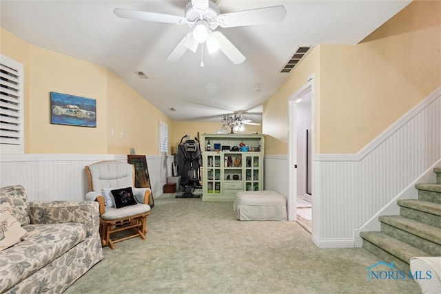 living room featuring ceiling fan, carpet floors, and vaulted ceiling