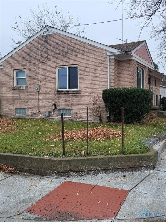 view of home's exterior featuring a yard