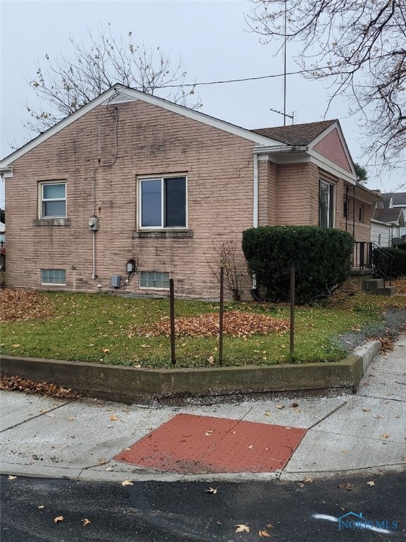 view of property exterior with a yard