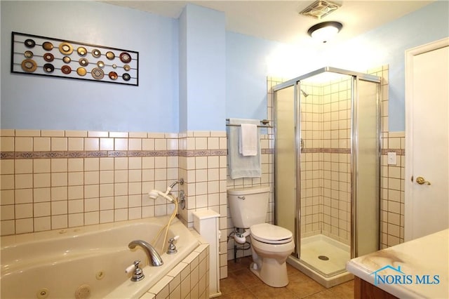 full bathroom with tile patterned flooring, vanity, toilet, and independent shower and bath