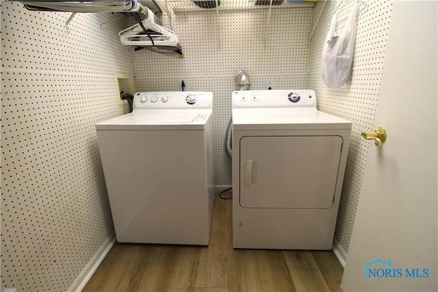 laundry room with dark hardwood / wood-style flooring and washer and dryer