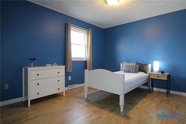 bedroom with hardwood / wood-style flooring