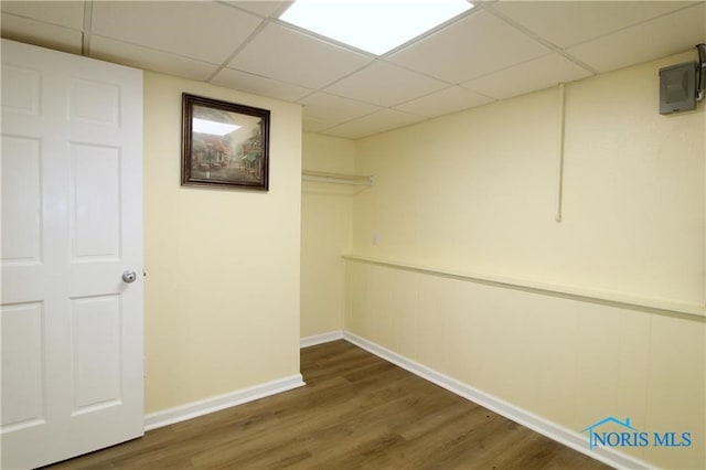 basement with dark wood-type flooring and a drop ceiling