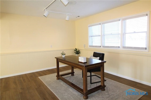 office space with dark wood-type flooring and rail lighting