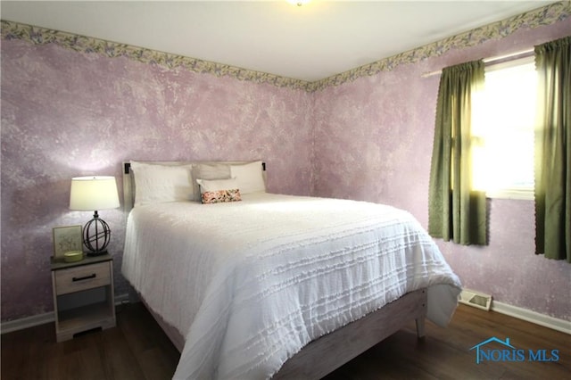 bedroom with dark wood-type flooring