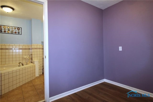 bathroom featuring hardwood / wood-style floors and a bath