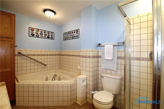 bathroom featuring tile patterned flooring, toilet, separate shower and tub, and tile walls