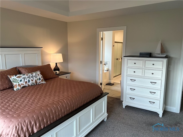 carpeted bedroom with ensuite bath