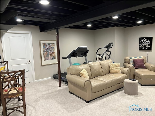 living room with beamed ceiling and carpet