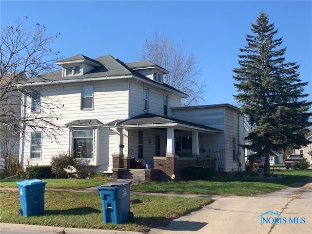 view of front of home with a porch and a front lawn