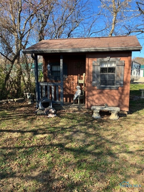 view of outdoor structure featuring a lawn