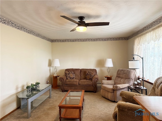 carpeted living room featuring ceiling fan