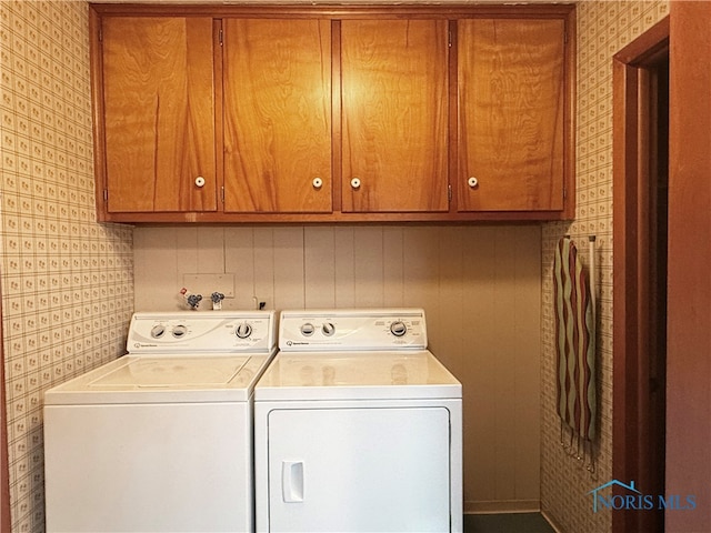 laundry area with cabinets and washing machine and dryer