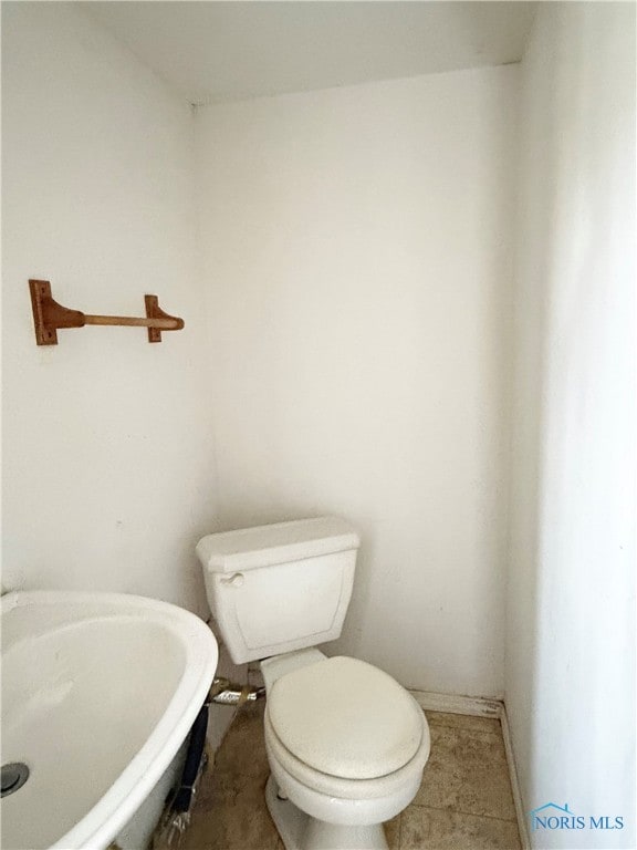 bathroom featuring tile patterned floors, toilet, and sink