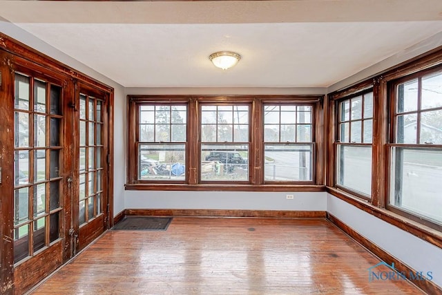 unfurnished sunroom featuring plenty of natural light