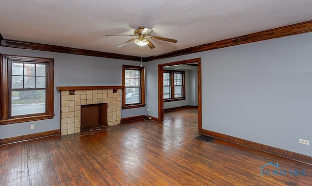 unfurnished living room with a tile fireplace, dark hardwood / wood-style flooring, plenty of natural light, and ceiling fan