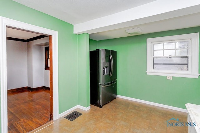 kitchen featuring stainless steel refrigerator with ice dispenser