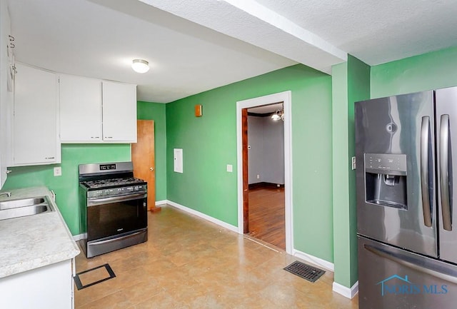 kitchen featuring white cabinets, sink, appliances with stainless steel finishes, and a textured ceiling