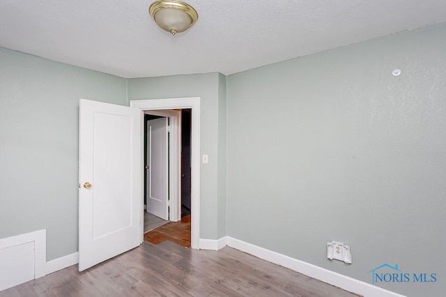 unfurnished room featuring wood-type flooring