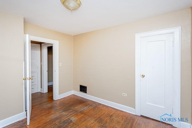 spare room with dark hardwood / wood-style flooring