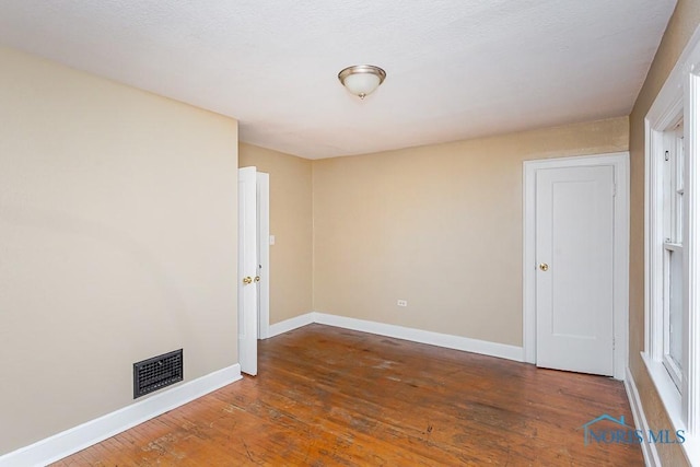 spare room featuring dark hardwood / wood-style floors