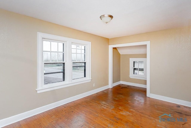 unfurnished room featuring hardwood / wood-style flooring