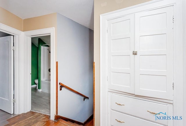 stairway with hardwood / wood-style flooring