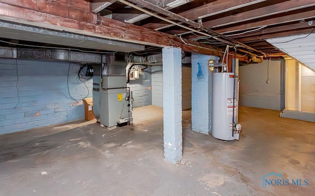 basement featuring gas water heater and heating unit