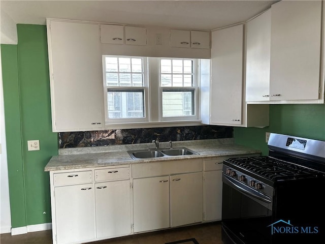 kitchen with white cabinets, black gas range, and sink