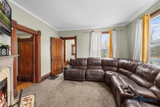 carpeted living room with a fireplace and ornamental molding