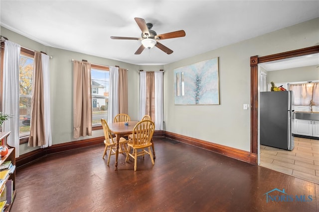 dining space featuring hardwood / wood-style flooring and ceiling fan