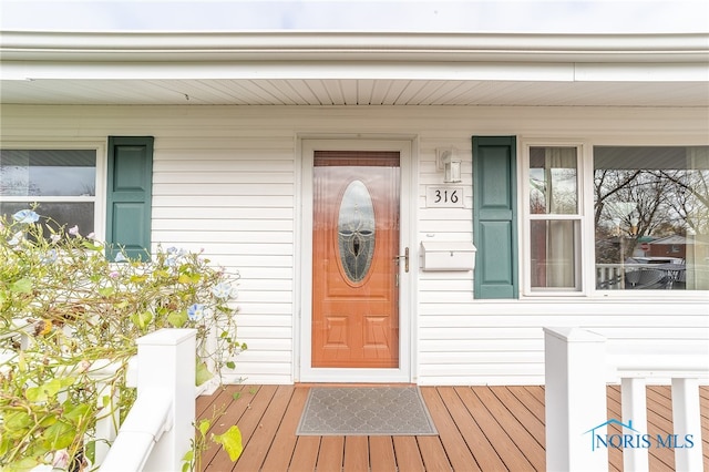 view of exterior entry with covered porch