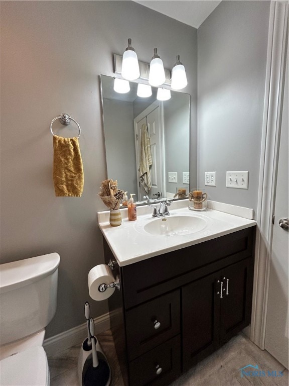 bathroom featuring tile patterned floors, vanity, and toilet