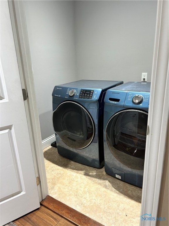 washroom featuring separate washer and dryer and hardwood / wood-style flooring