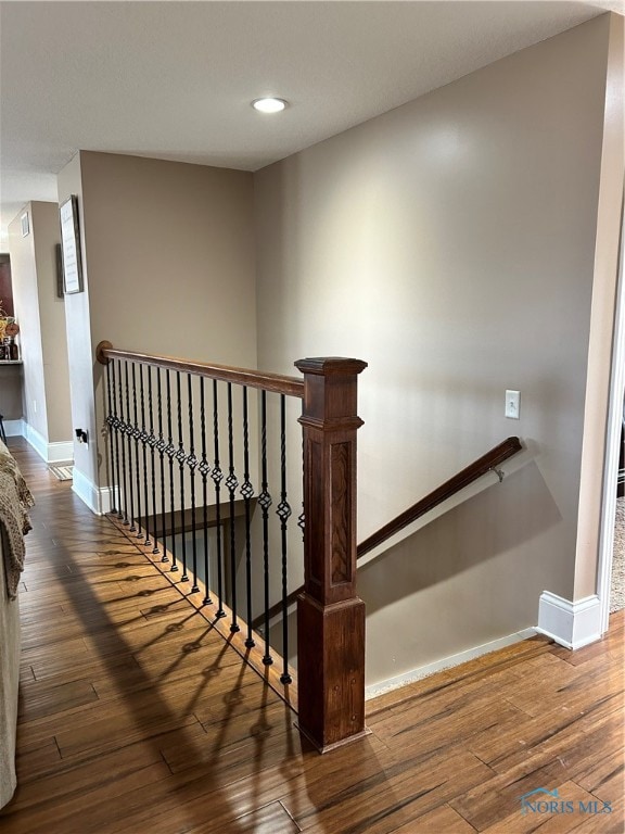 stairs with wood-type flooring