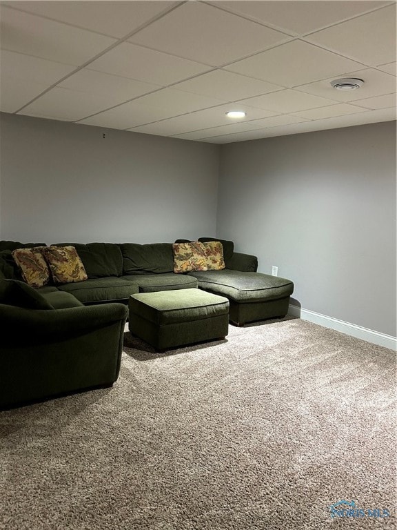 carpeted living room with a paneled ceiling