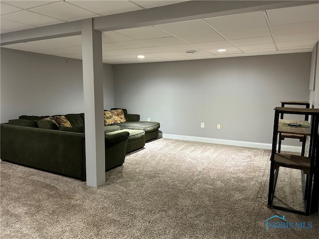 living room featuring carpet flooring and a paneled ceiling