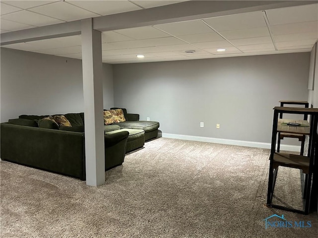 living room with a drop ceiling and carpet floors